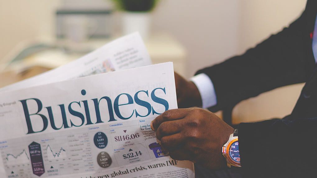 man holding business newspaper